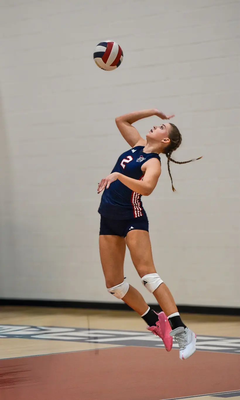 Sienna Moore jumping to serve